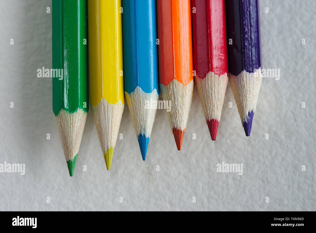 six rainbow colored pencils on a white paper Stock Photo Alamy