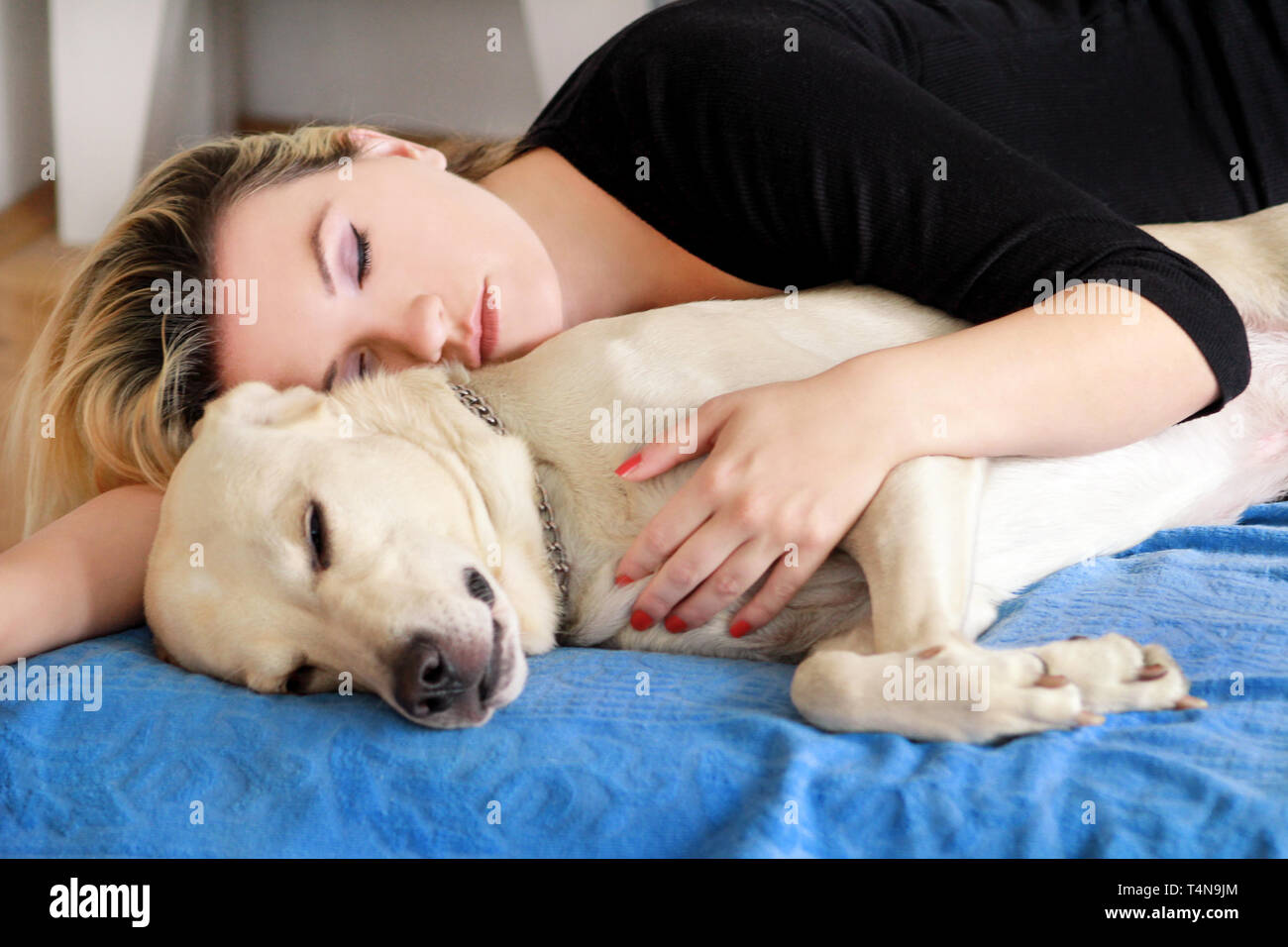 Woman with cute dogs at home. Handsome girl resting and sleeping with