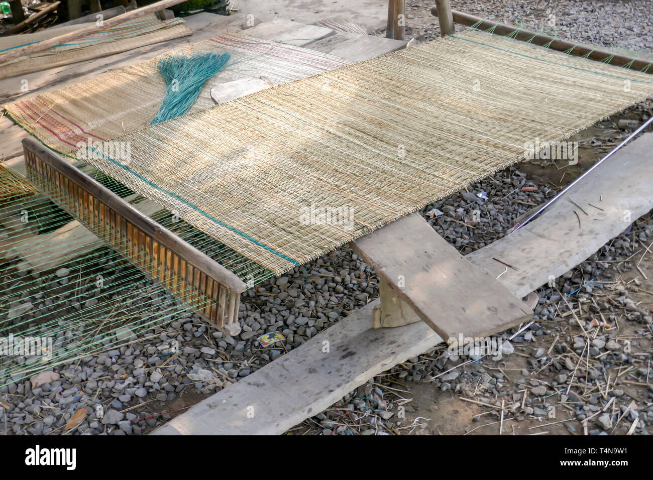 Loom used to make traditional reed sleeping mats in rural village along