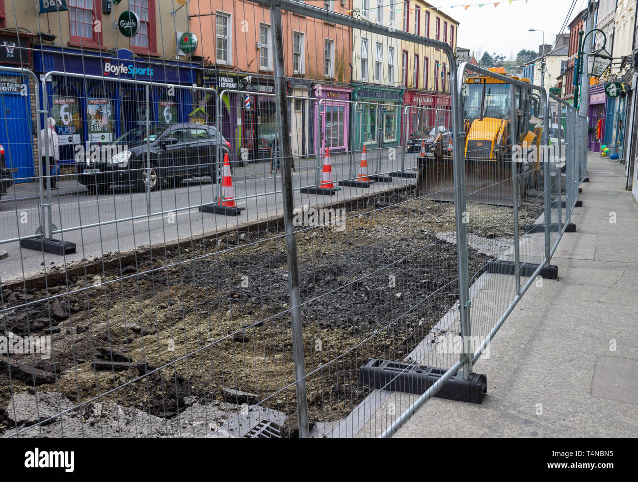Roadworks behind a safety fence blocking the high street. Skibbereen, Cork, Ireland Stock Photo