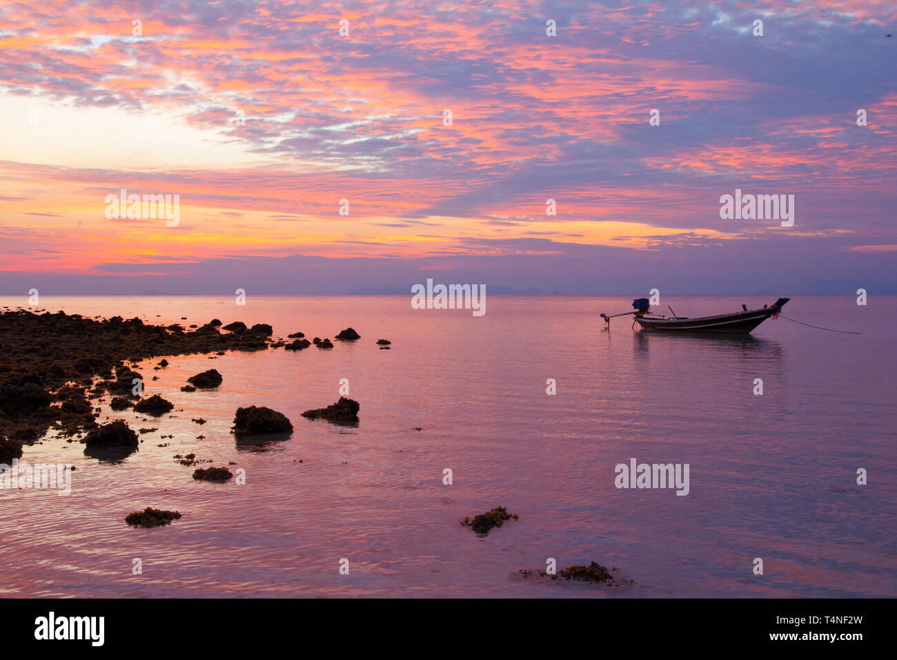 Fisherman boat at sunset Stock Photo - Alamy