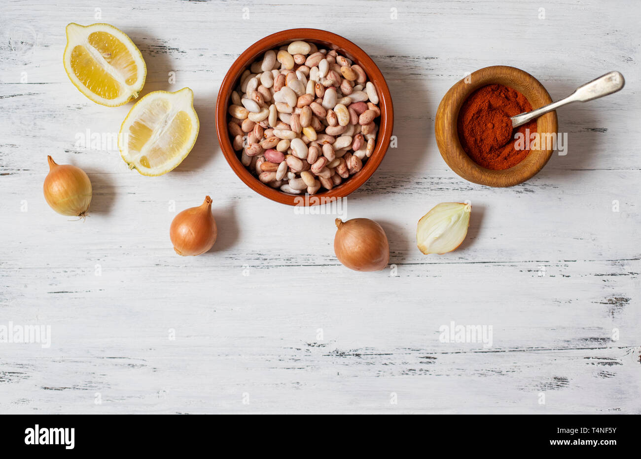 Prebranac ingredients. Balkan baked beans. Serbian, Montenegrin, Bosnian, Croatian, Slovenian cuisine. Uncooked beans, onion, lemon, paprika powder Stock Photo