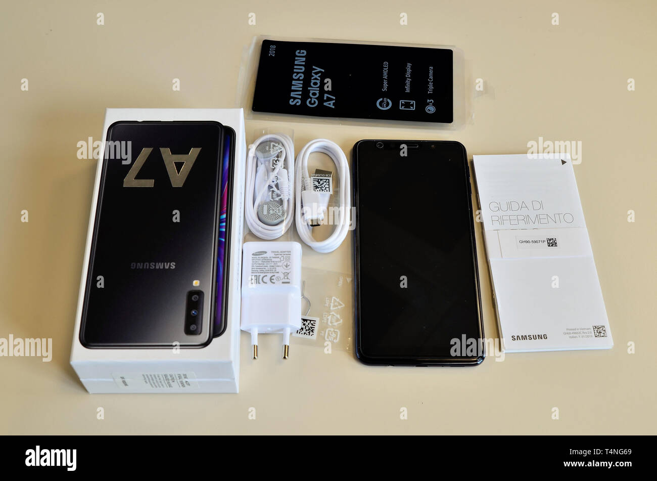Turin, Piedmont, Italy. April 2019. The package of a Samsung Galaxy A7 has been opened, the smartphone and the accessories are visible: charger, earph Stock Photo