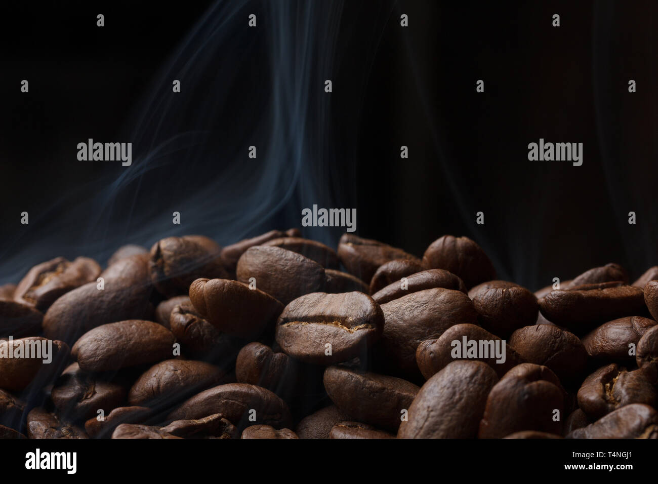 Coffee beans roasting with smoke Stock Photo - Alamy