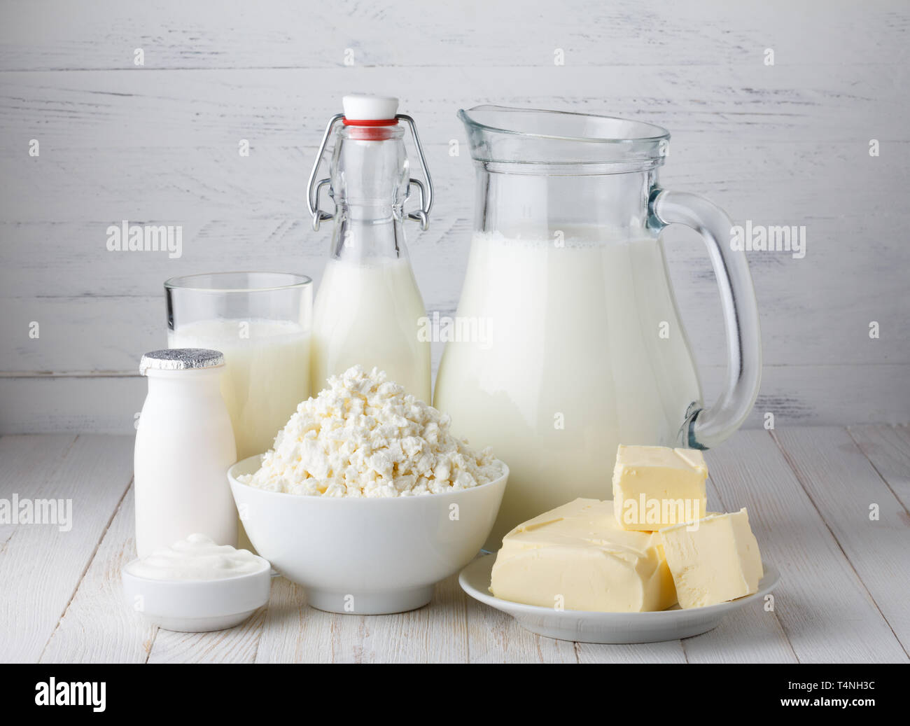 Dairy products, milk, cottage cheese, yogurt, sour cream and butter on wooden table Stock Photo