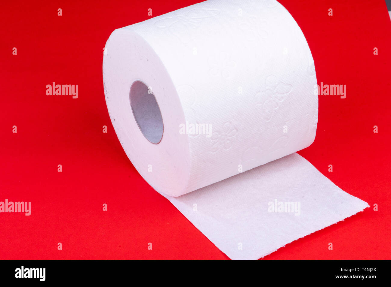 toilet paper roll on red background half unrolled Stock Photo Alamy