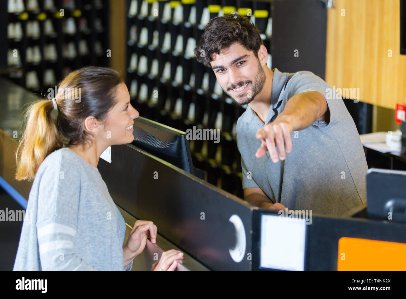 bowling worker giving directions to customer Stock Photo