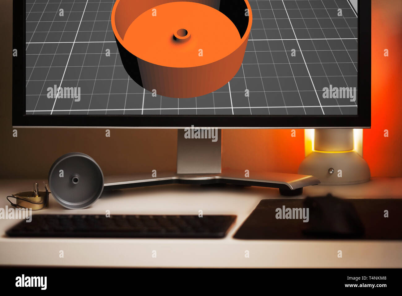 3D modeling of an object shown on a computer screen for 3D printing, and final 3D print on the desk. Stock Photo