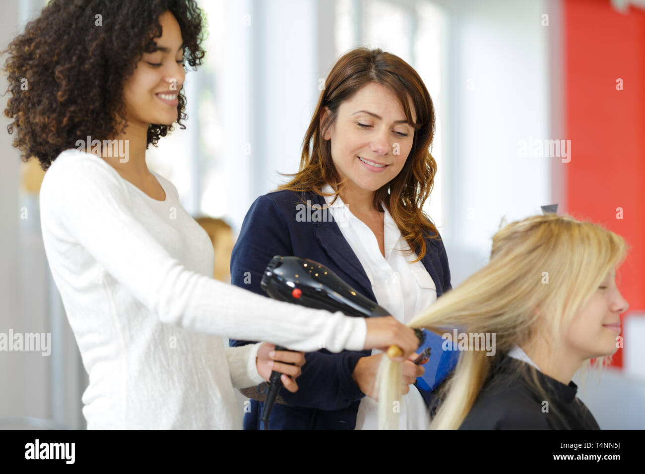 student girl in hairdressing learning how to cut hair Stock Photo Alamy
