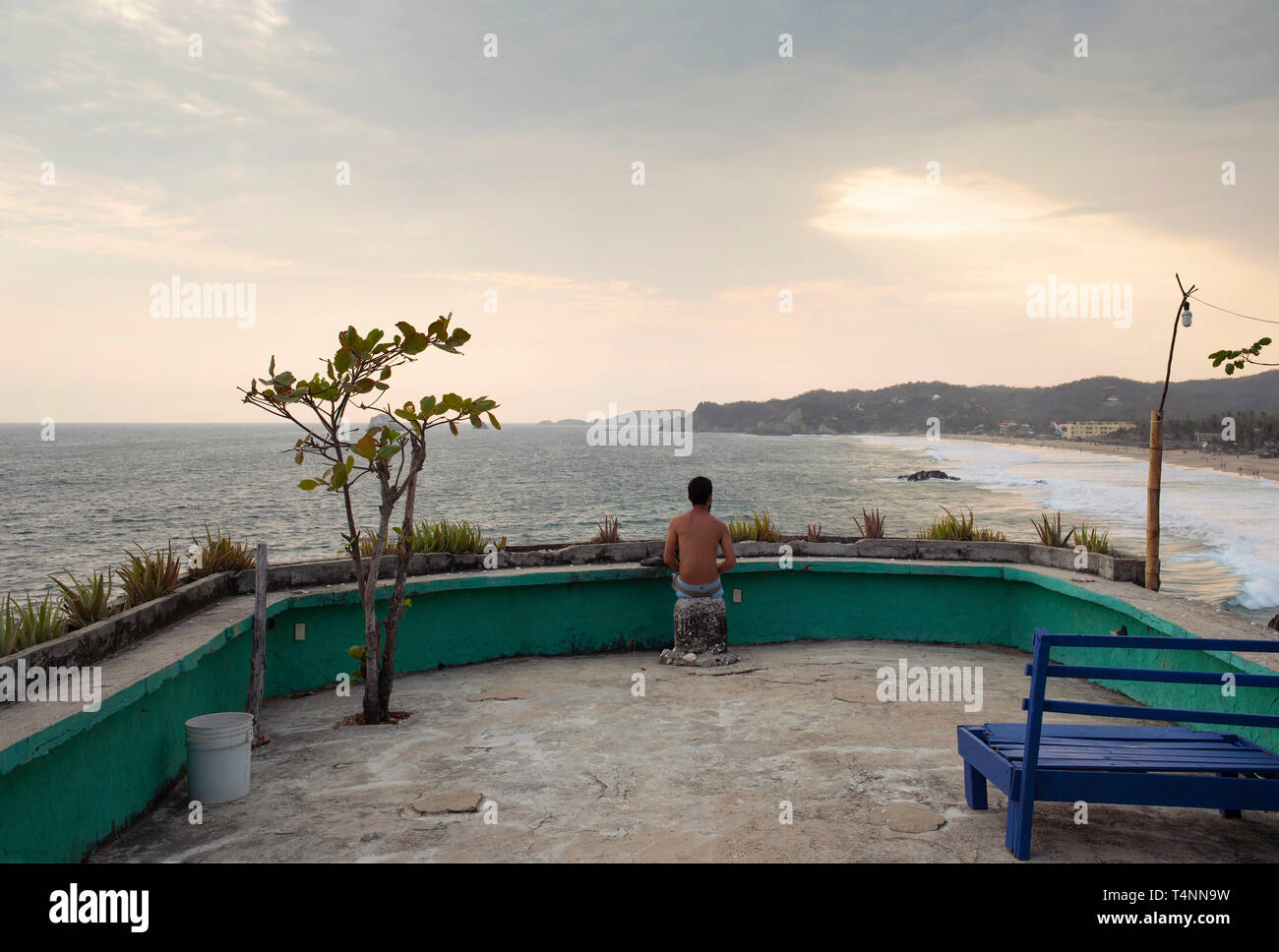 Rear view of man enjoying the coastal views in Zipolite. Oaxaca State, Mexico. Apr 2019 Stock Photo