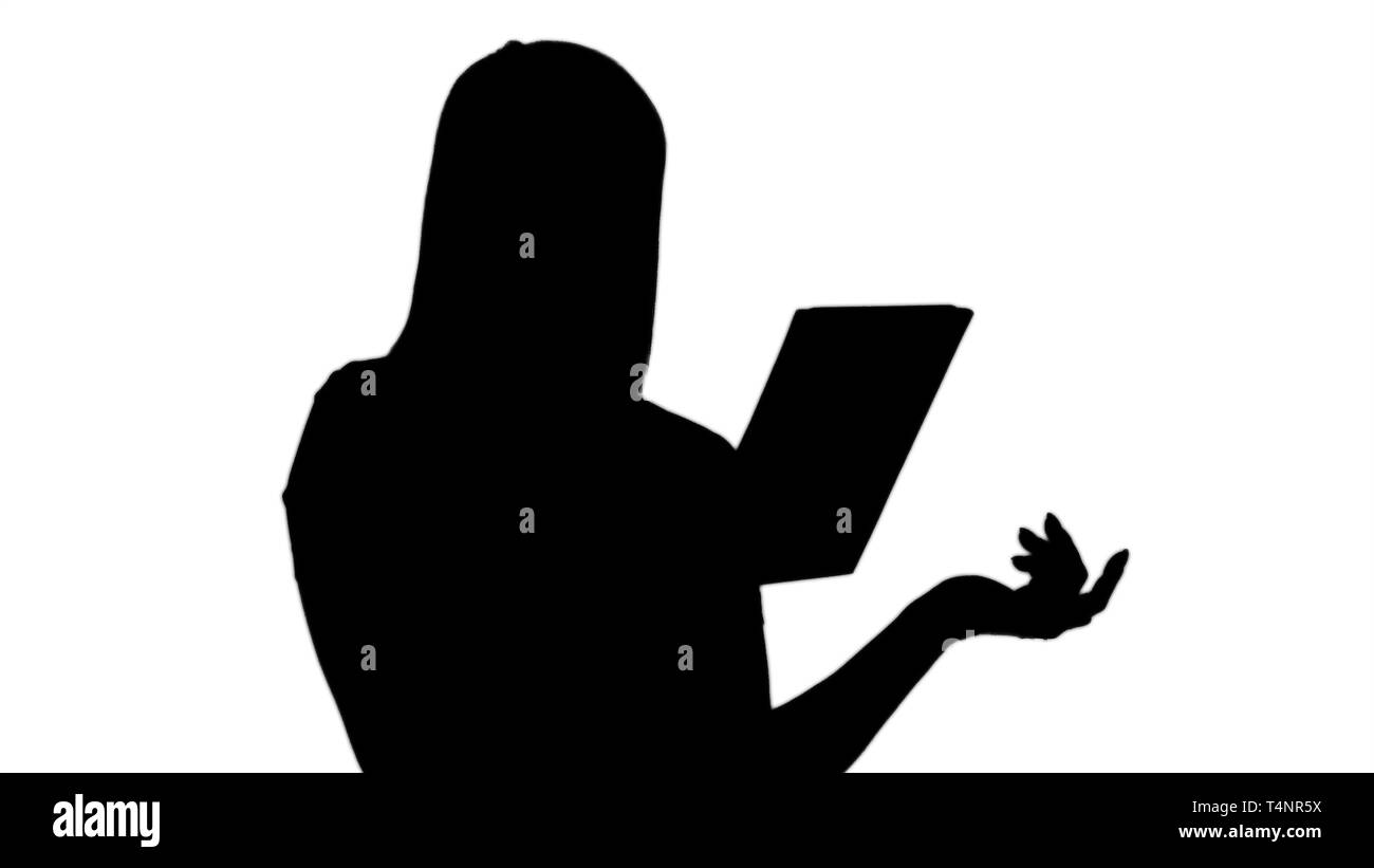 Close up. Silhouette Happy woman chatting over a video call, by using a tablet. Professional shot in 4K resolution. 005. You can use it e.g. in your c Stock Photo