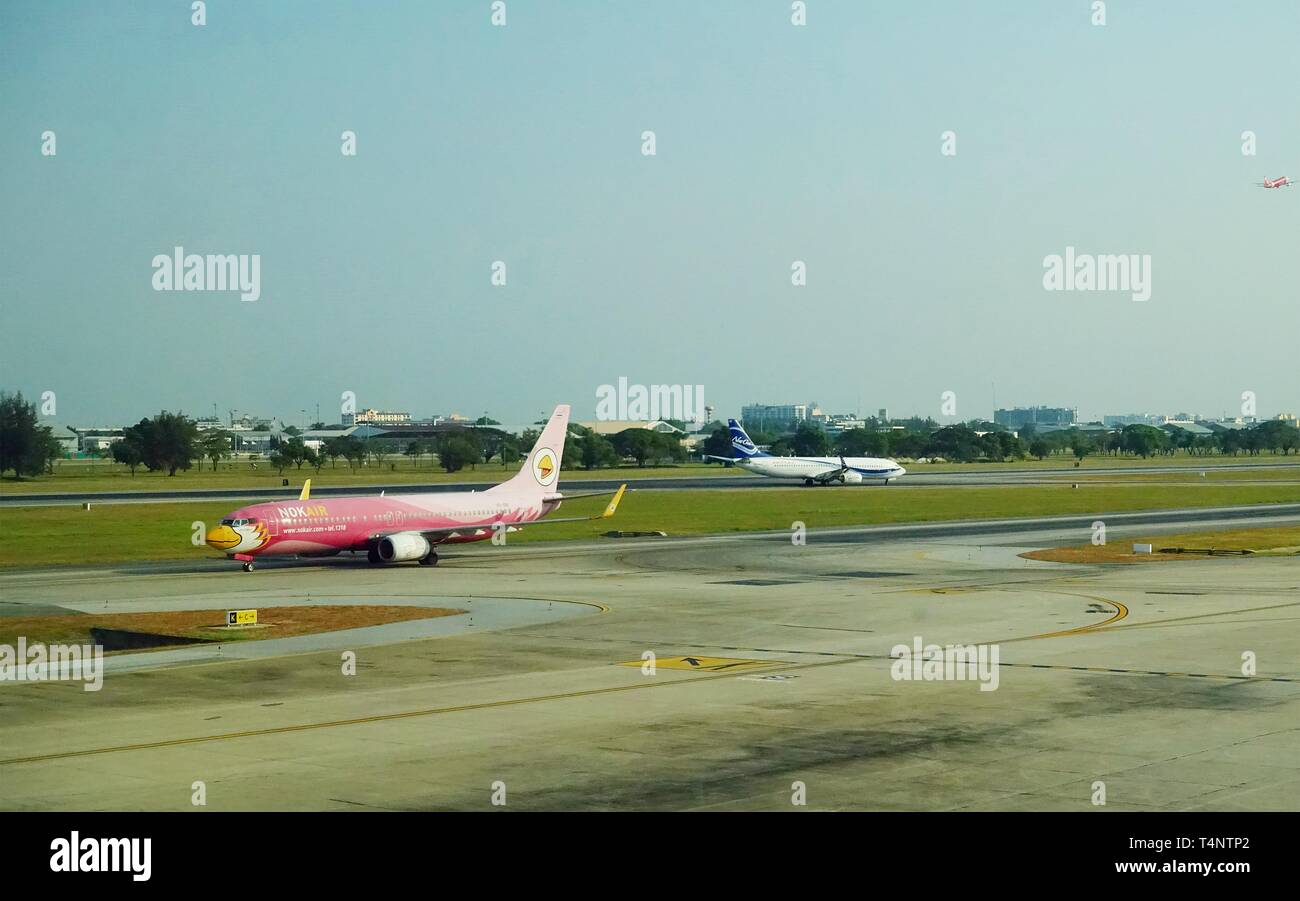 Airplanes of Nok Air, one of the main low cost airlines in Asia, is landing on an airport runway, after it's flight. Stock Photo