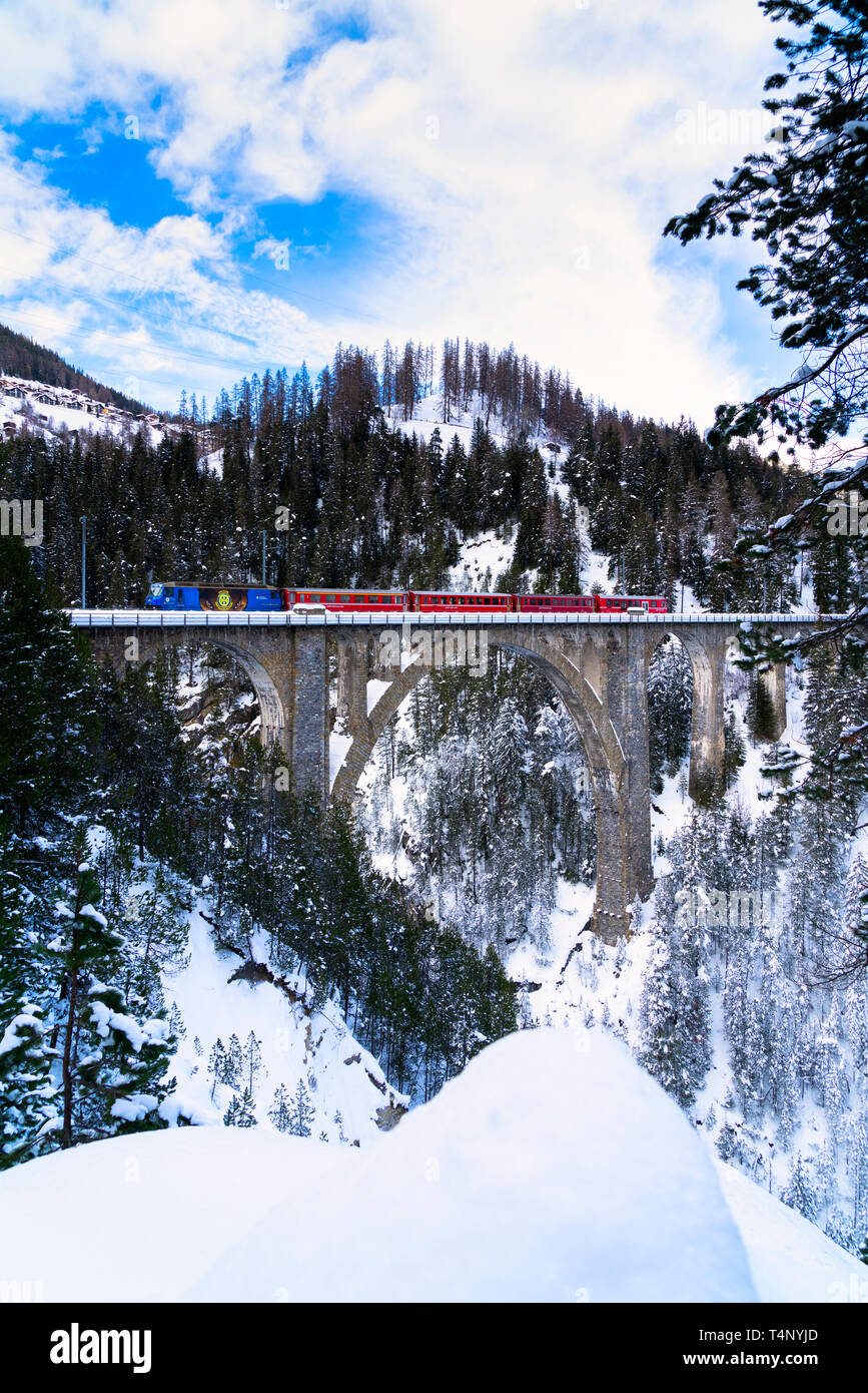 Bernina Express train on Wiesen Viaduct during winter, Davos, canton of Graubunden, Switzerland Stock Photo