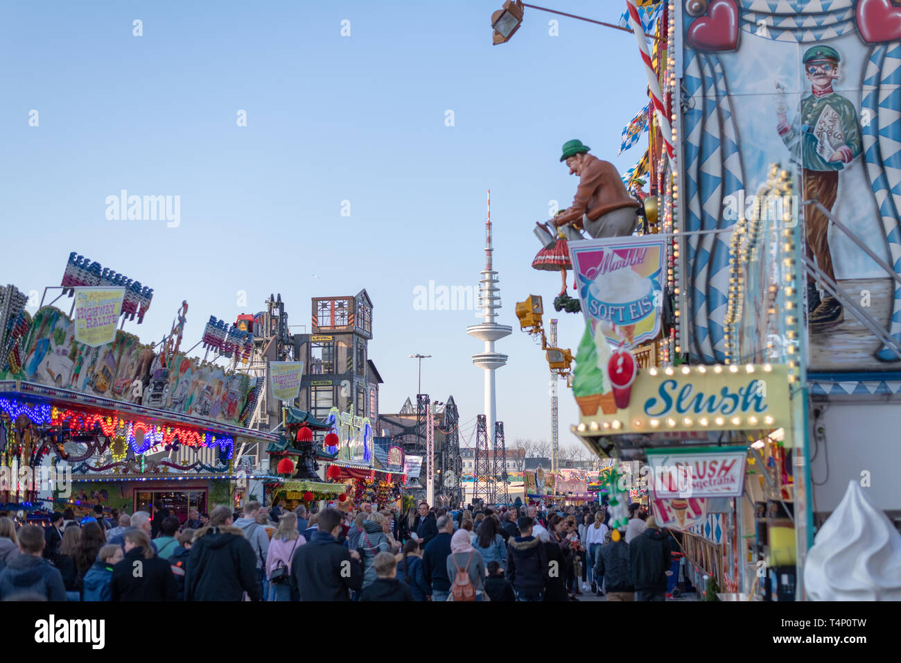 Hamburg, Germany - People walking on the streets in the amusement park DOM, on both sides of various entertainment facilities Stock Photo