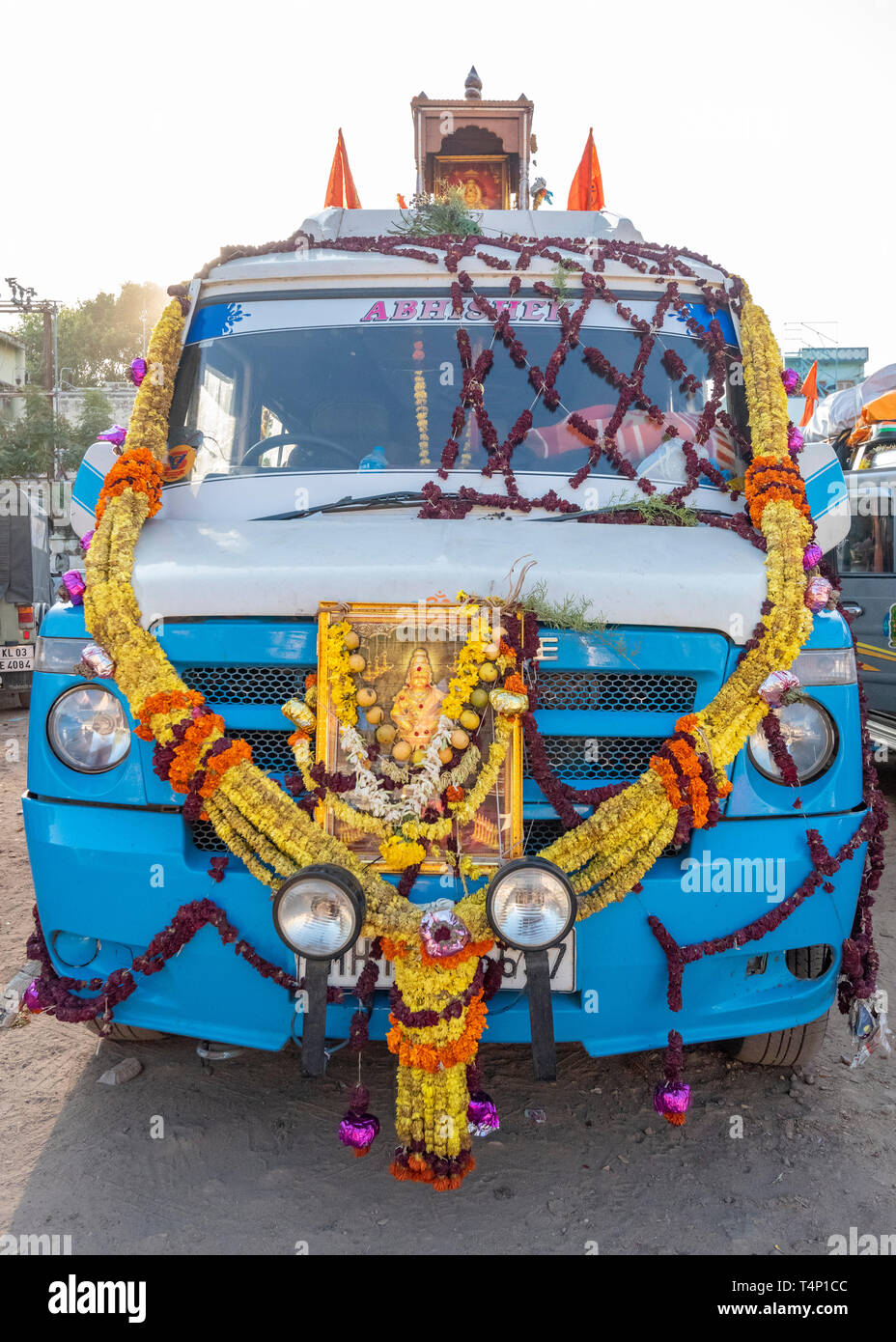 Vertical close up of a minibus decorated with garlands and wreaths for Pongal. Stock Photo