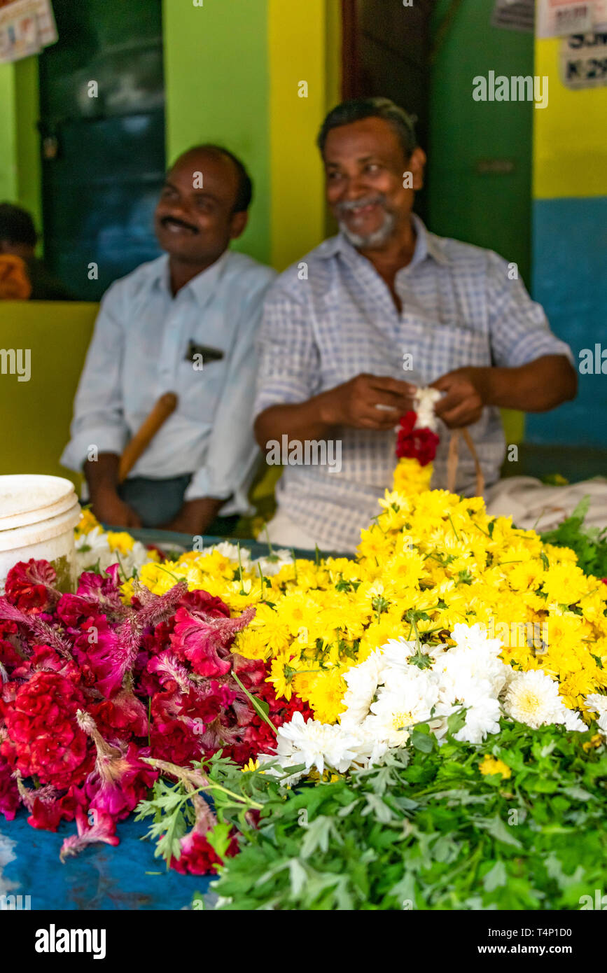 Vertical view of men making garlands at Mattuthavani flower market in Madurai, India. Stock Photo