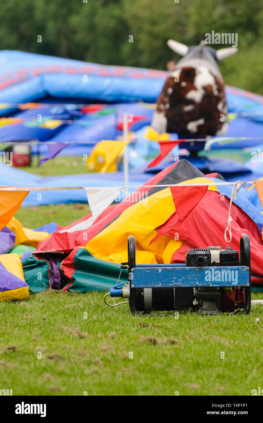 Bouncy castles laid out and ready to be inflated Stock Photo