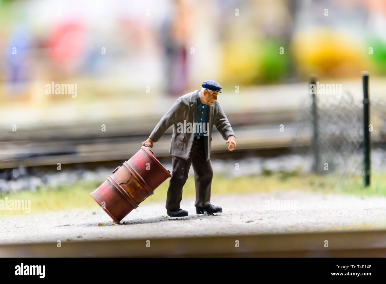 Miniature model of a man pulling an oil drum, at Kolejkowo, Wrocław, Wroclaw, Wroklaw, Poland Stock Photo