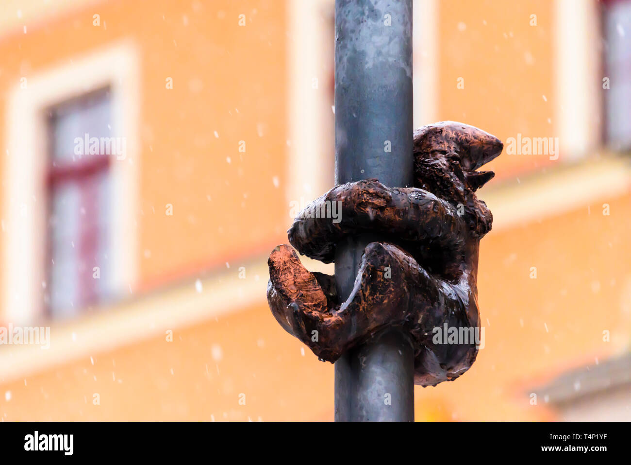 One of the brass gnomes (krasnale, krasnoludki) hanging onto a street light in Wrocław, Wroklaw, Poland Stock Photo