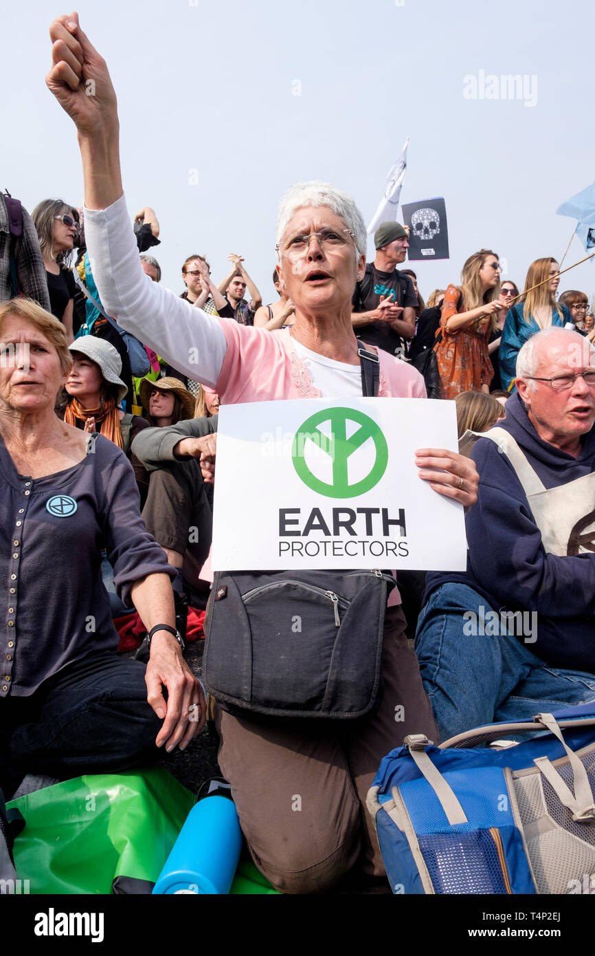 Extinction Rebellion activists occupying Waterloo Bridge in April 2019: A mature female protester chants before police begin arrests. Stock Photo