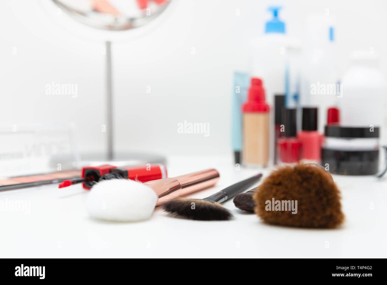 Decorative cosmetics, makeup products and brushes on white background Stock Photo