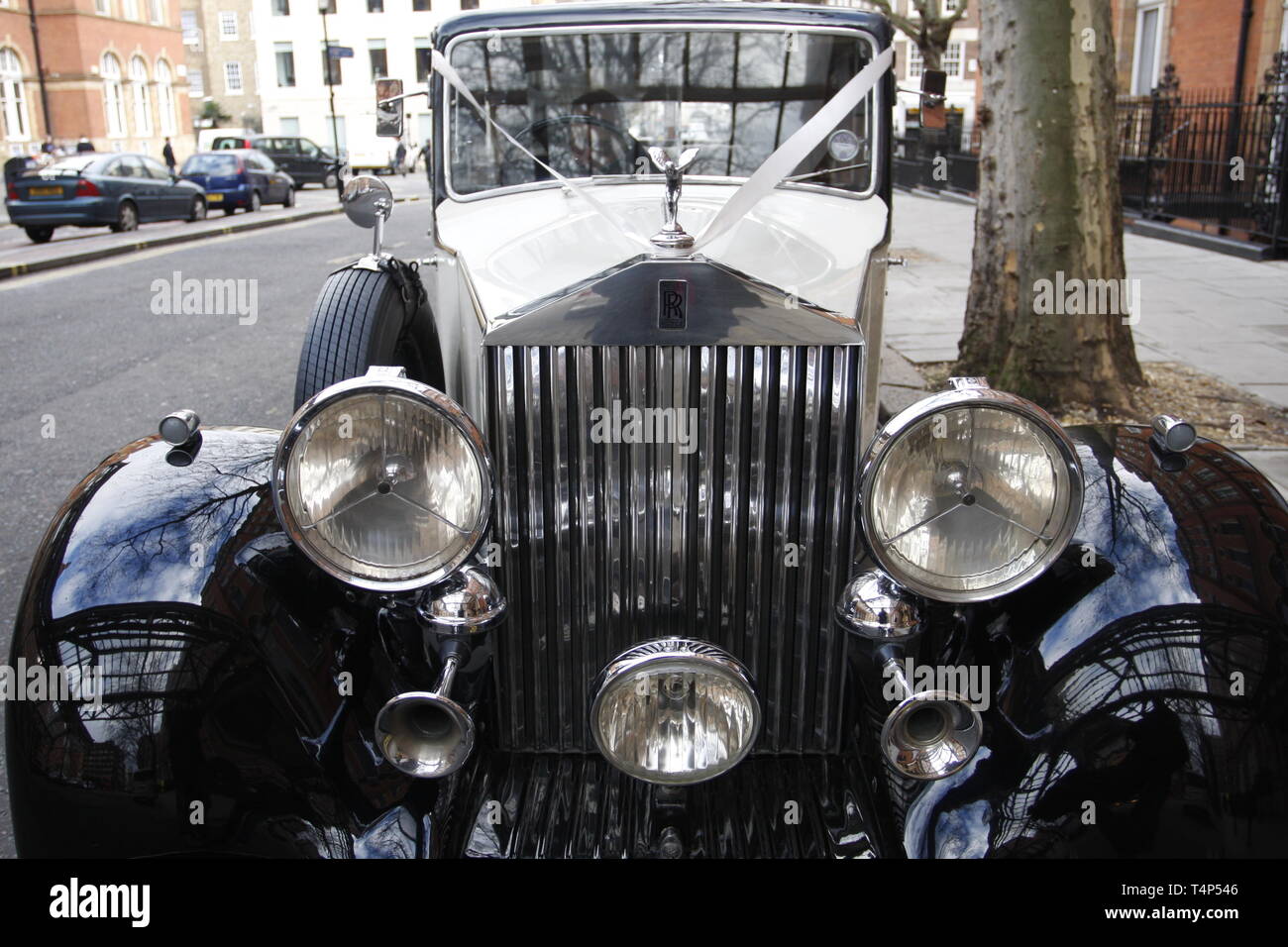 Early XX century Rolls Royce on summer street in London in mid 2000-s, a popular hire for weddings and other function, still reliable and elegant car. Stock Photo