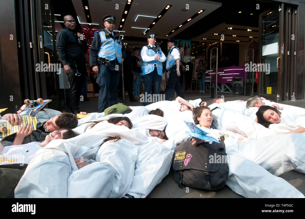 Extinction Rebellion protest, London September 17th 2019. Oxford Circus. Young people stage die-in wearing haz chem suits in front of shops to draw at Stock Photo
