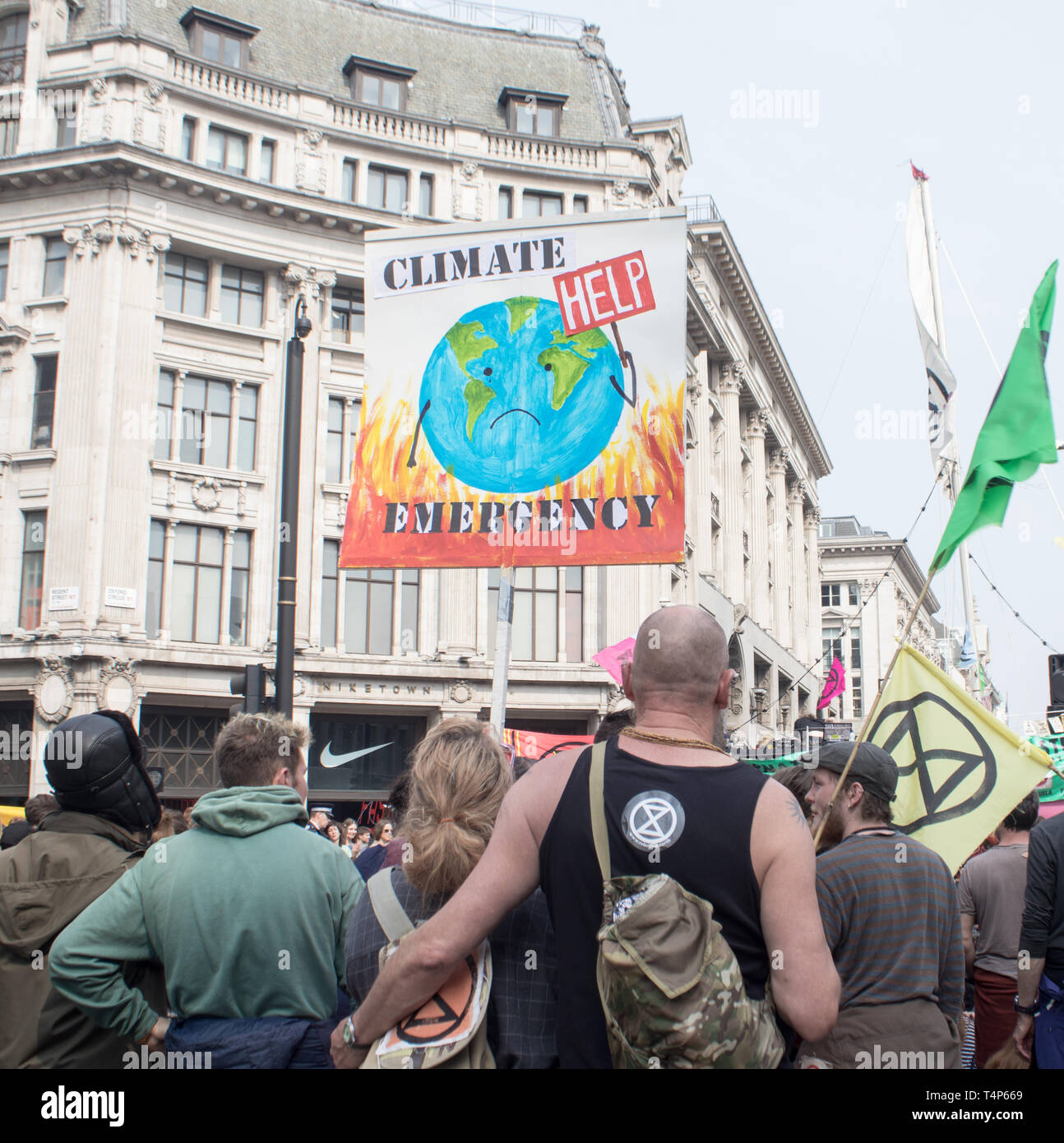 London, UK, April 17 2019 - Protesters hold a banner and an Extinction Rebellion flag at a climate change protest outside Oxford Circus underground st Stock Photo