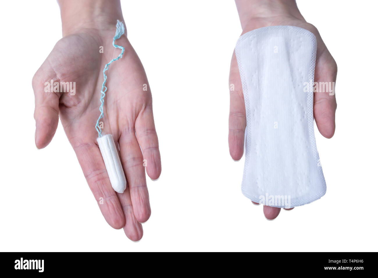 Tampon and sanitary napkin as hygiene article in woman hand in front of white background Stock