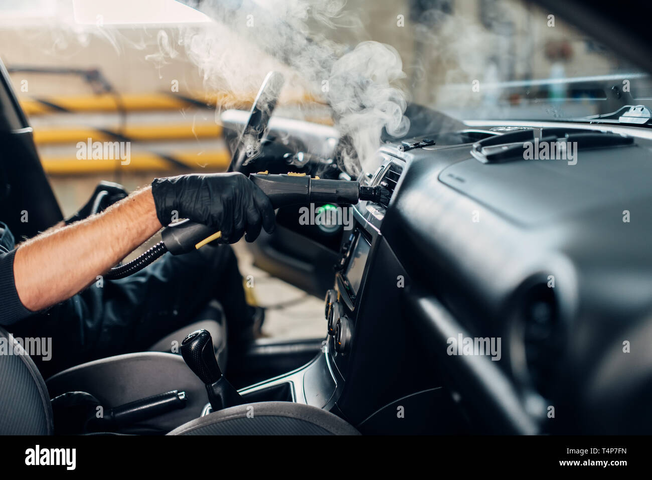 Carwash Service Male Worker In Gloves Removing Dust And