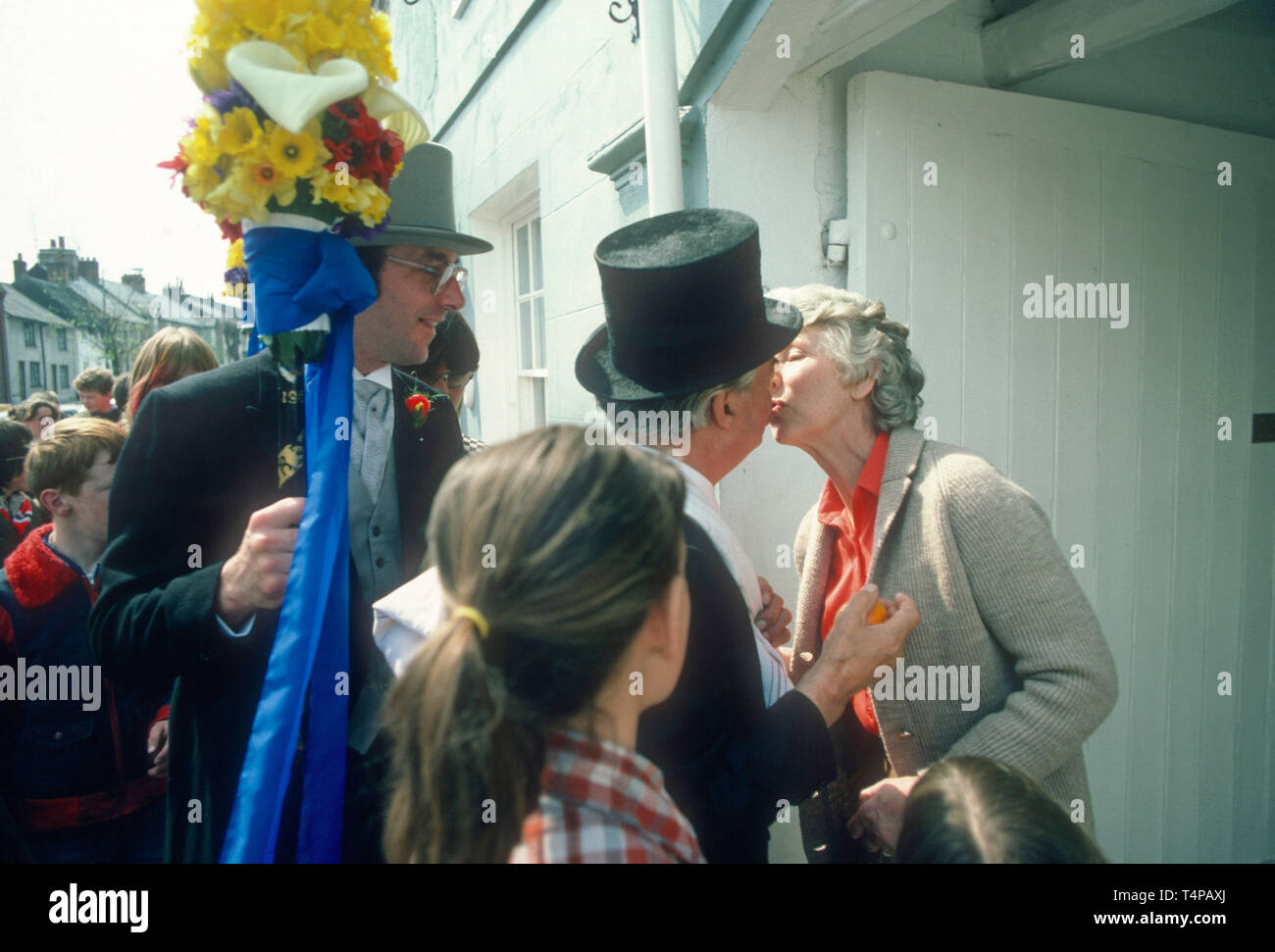 The orangeman takes a kiss from a resident at Hungerford Hocktide, UK in 1982 Stock Photo