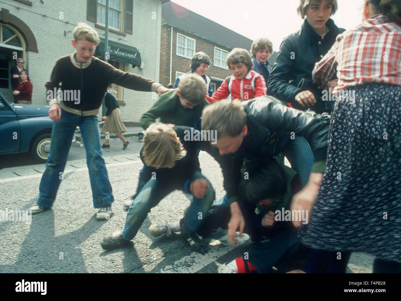 Children scamble for pennies and oranges at Hungerford Hocktide, UK in 1982 Stock Photo