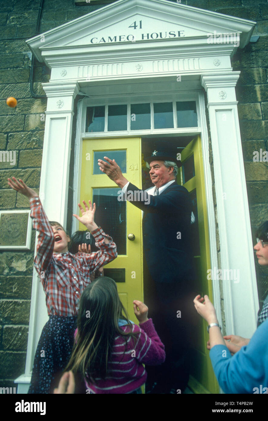 Orangeman throws an orange into the crowd at Hungerford Hocktide, UK in 1982 Stock Photo