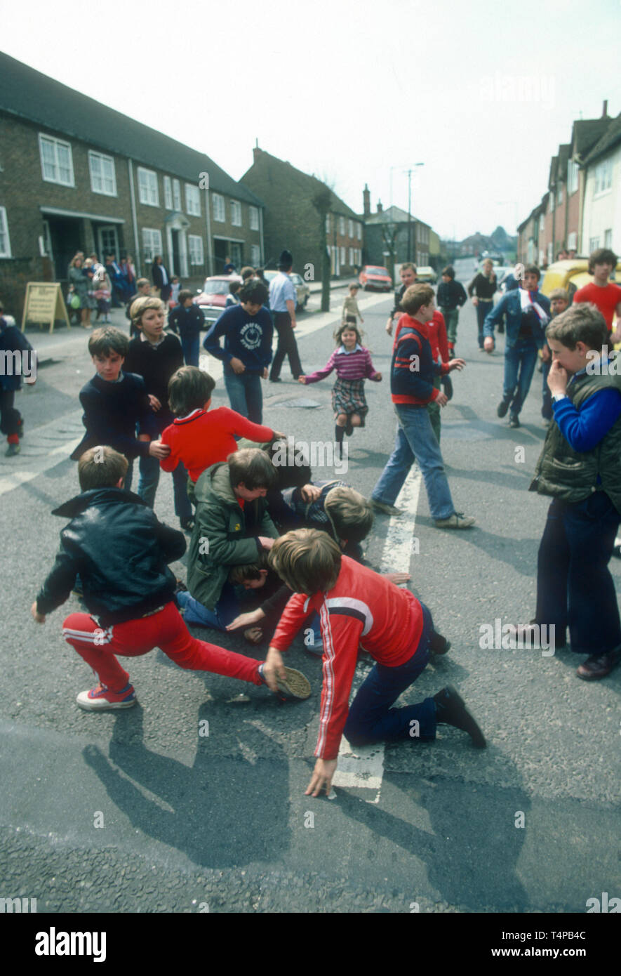 Children scamble for pennies and oranges at Hungerford Hocktide, UK in 1982 Stock Photo