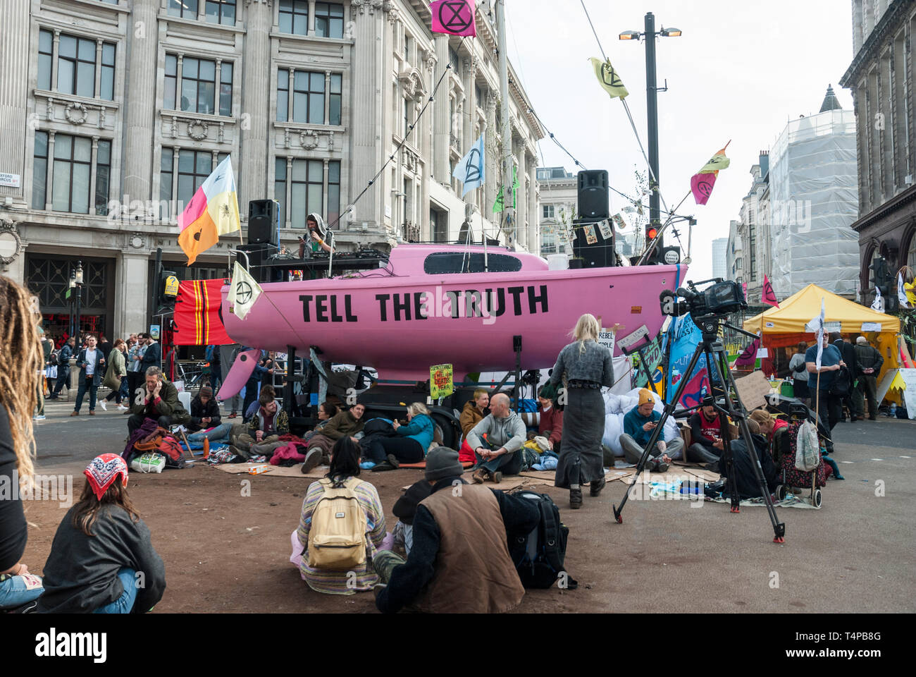 Extinction Rebellion' protesters against climate change block and occupy  Oxford Circus with a bright pink yacht displaying a 'Tell the Truth' sign  Stock Photo - Alamy