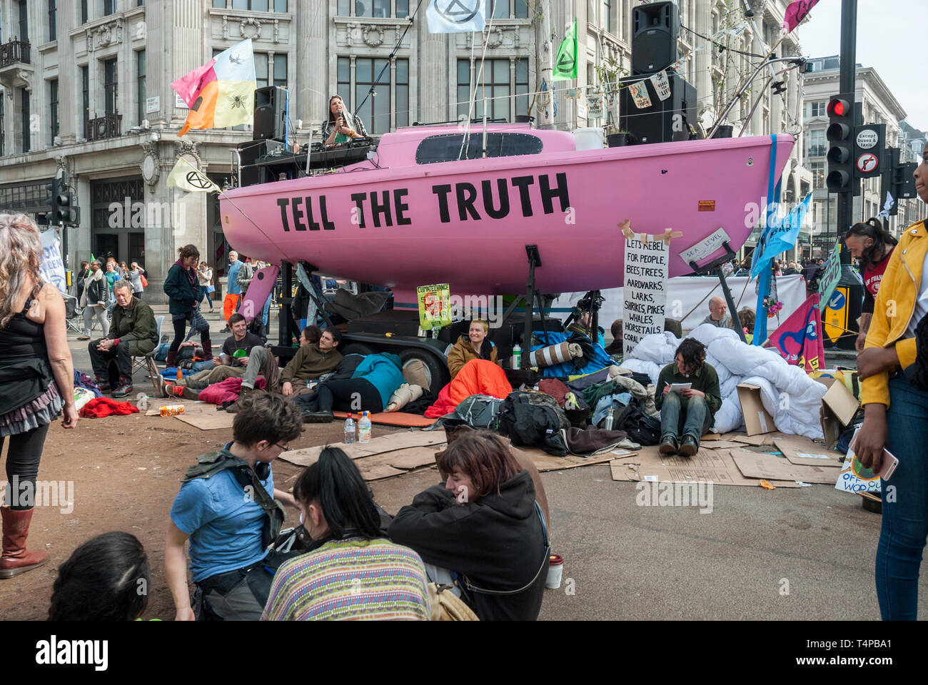 Extinction Rebellion' protesters against climate change block and occupy  Oxford Circus with a bright pink yacht displaying a 'Tell the Truth' sign  Stock Photo - Alamy