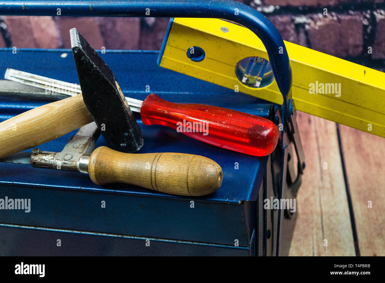 Different Tools like hammer,screw driver and spirit level on a tool box