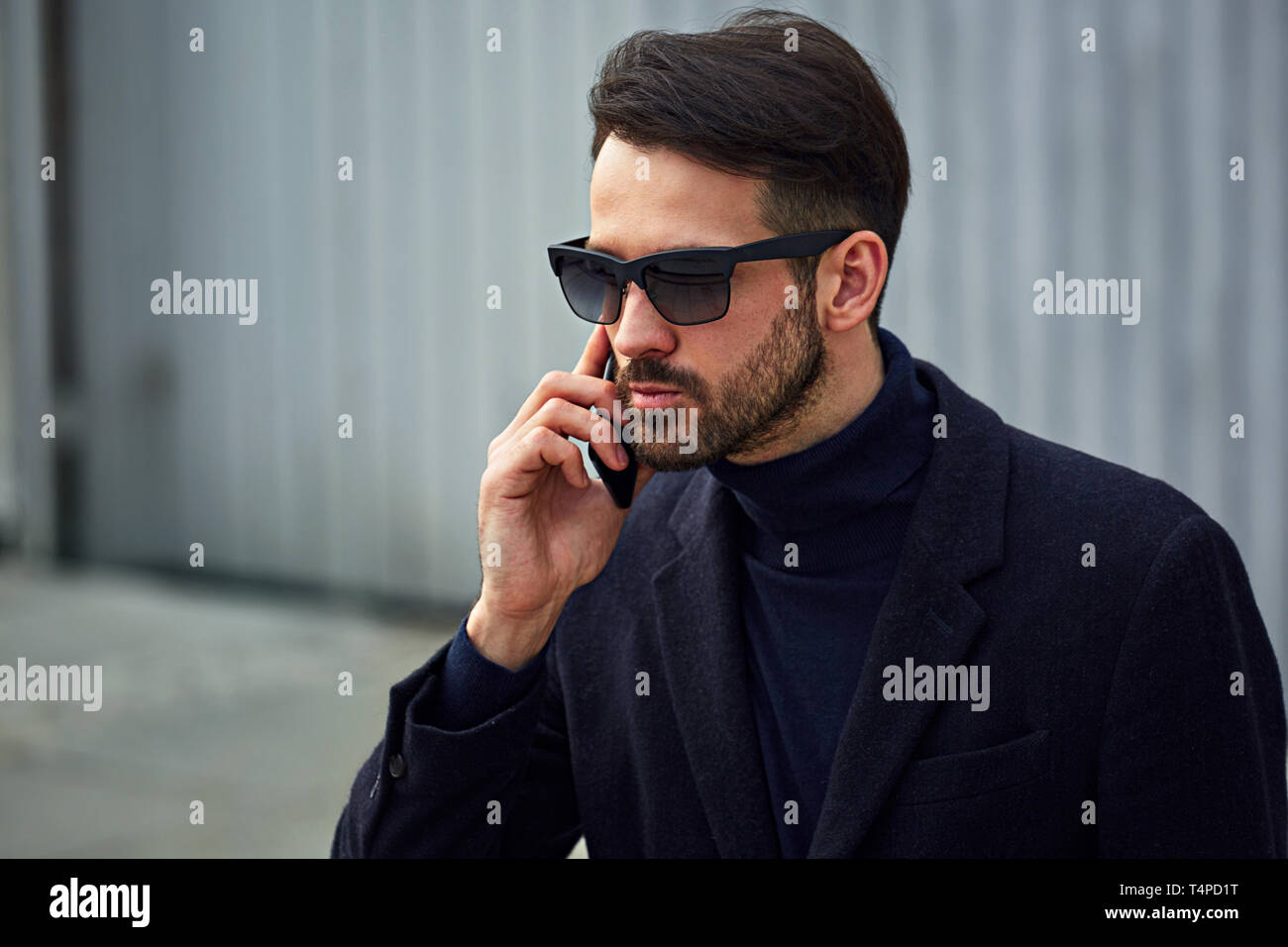 Fashion Beard Style Business Handsome Male Model In Fashion Sunglasses And Blue Coat With Serious Concentrated Look Talking On Mobile Phone On Wall Ou Stock Photo Alamy