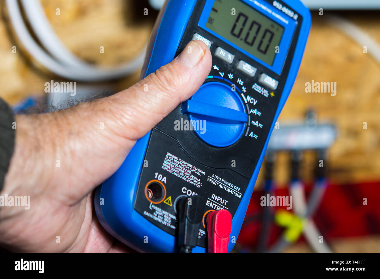 Electrician checks the connection of television cables on the panel