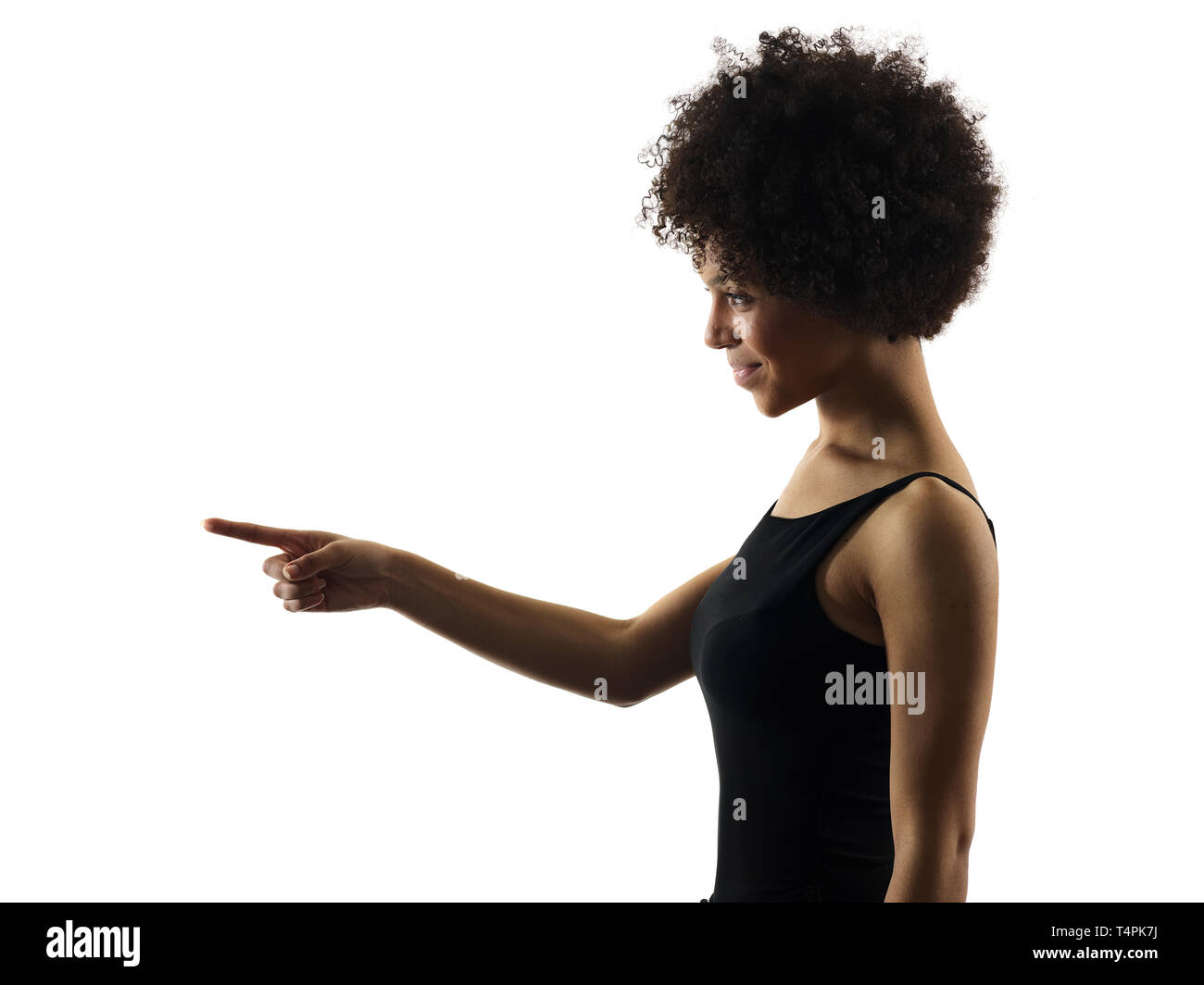 one mixed race african young teenager girl woman pointing  in studio shadow silhouette isolated on white background Stock Photo