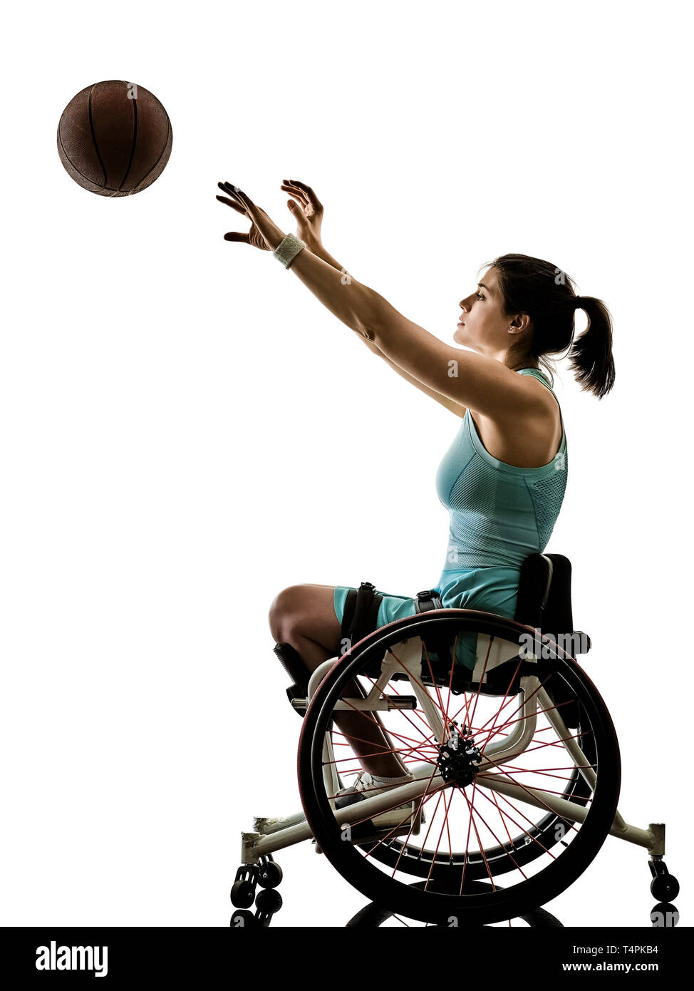 one caucasian young handicapped basket ball player woman in wheelchair sport  tudio in silhouette isolated on white background Stock Photo