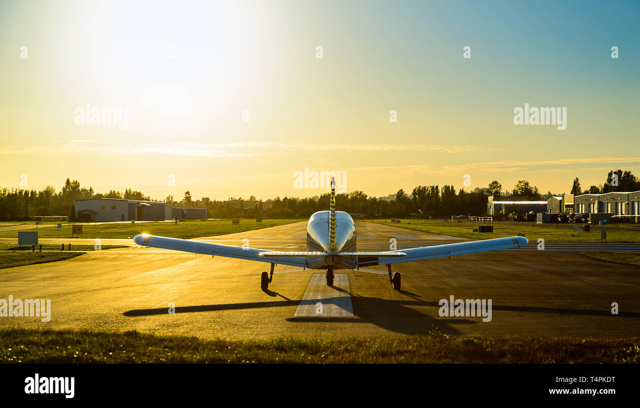 Small plane ready to take off at the airport at sunrise. Stock Photo