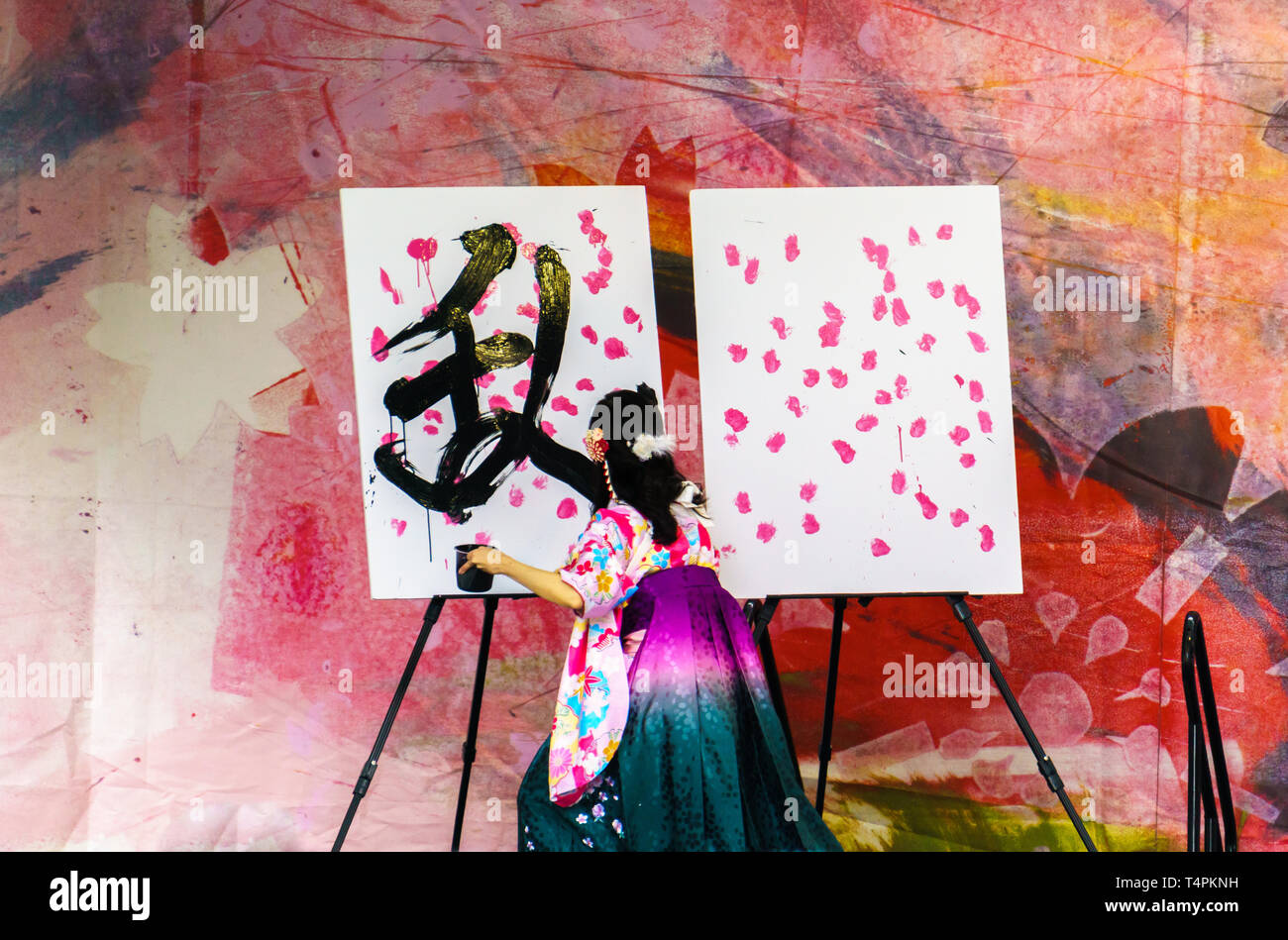Vancouver, BC / Canada - April 14, 2019: Japanese woman wearing kimono is creating art by painting at Sakura Days Japan Fair, Cherry Blossom Festival Stock Photo