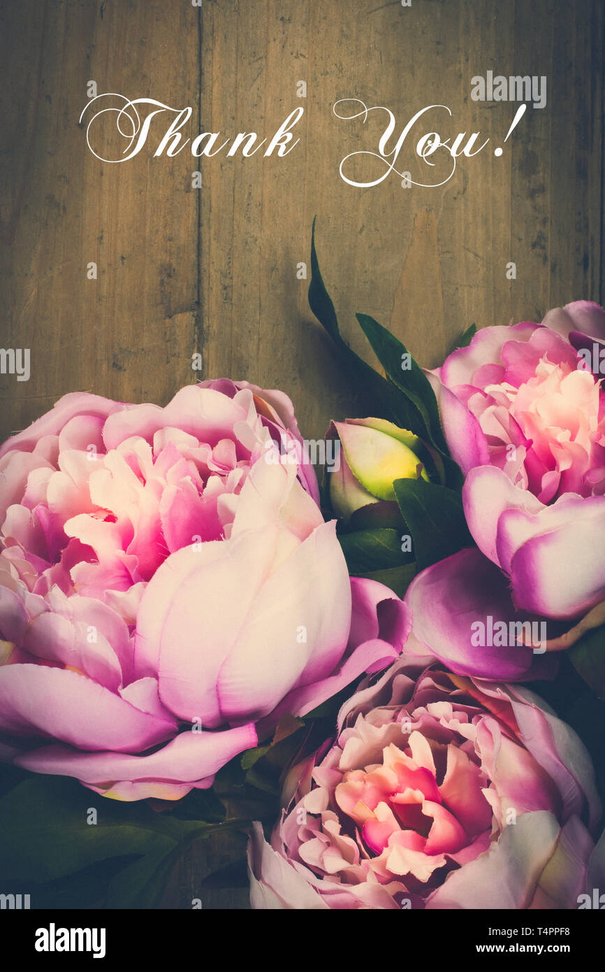 Thank you card with pink peony flowers on wooden background.Vintage tone. Administrative, professionals day, appreciation greeting card. Stock Photo