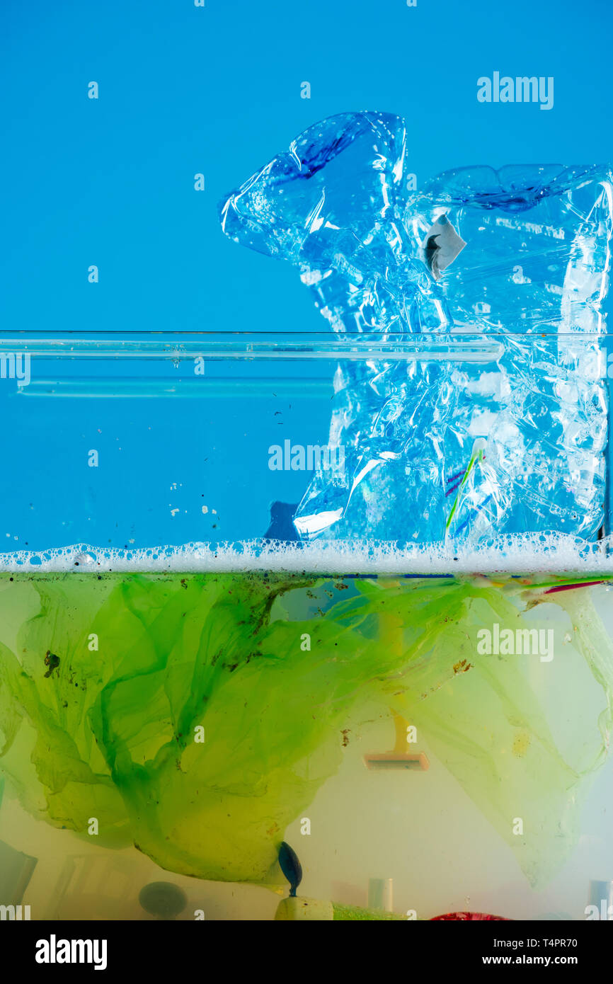 Blue plastic. Crumpled used plastic bottles polluting water and