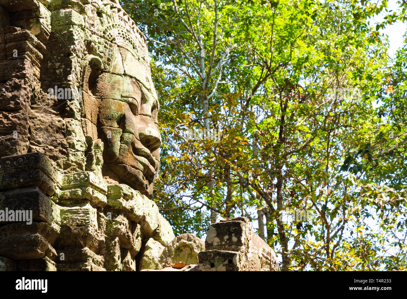 Large carved human face on tower at entrance to Ta Som temple in Angkor Wat archeological park, Cambodia Stock Photo