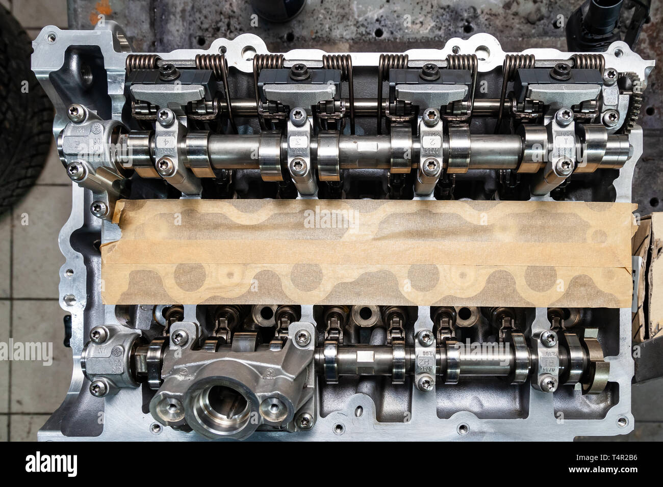 Top view of a four-cylinder engine with new camshaft dissembled and removed from car on a workbench in a vehicle repair workshop. Auto service industr Stock Photo