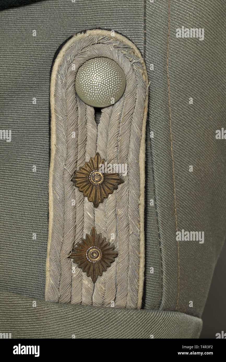 A field tunic for a Hauptsturmführer attached to the 14th Waffen-Grenadier Division 'Galizien' of the Waffen-SS (Ukrainian Nr. 1) Made of field-grey gabardine with dark green contrasting collar, gray-brown imitation silk liner, shoulder boards underlaid with black cloth. 20th century, Editorial-Use-Only Stock Photo