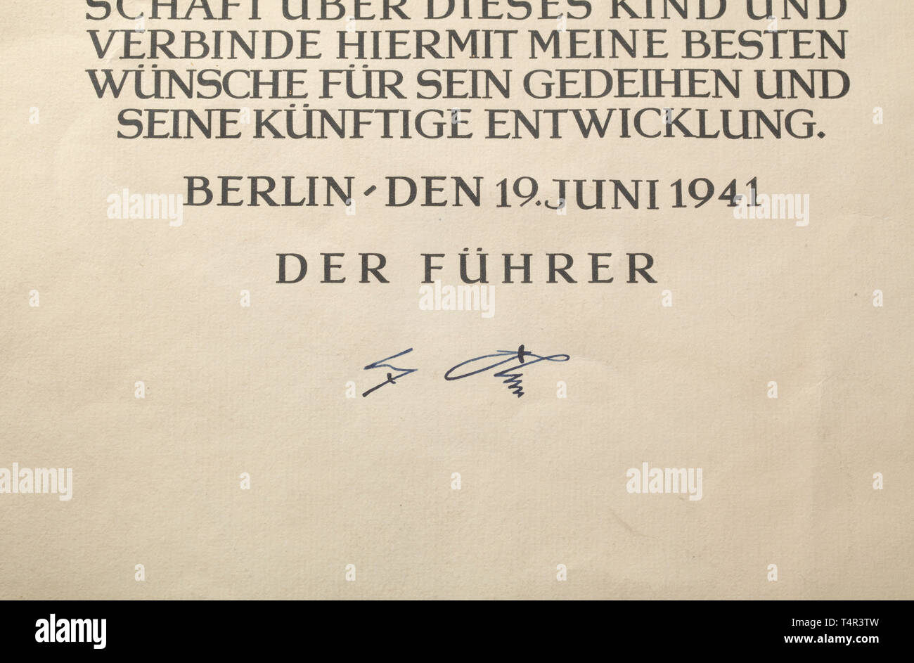 Adolf Hitler - a godparent document from the Reich Chancellery Large-format document, rendered in multiple-colours for the birth of Gisela Margarete West. The child of the married couple Gustav and Lisbeth West was born on 19 june 1941 in the air raid shelter of the New Reich Chancellery. Original signature of Adolf Hitler at the bottom, centrally small tear and with light signs of age. Dimensions of the document 25.5 x 35.5 cm. One of the rarest documents of the Third Reich period. historic, historical, document, documents, certificate, certificates, NS, National Socialism, Editorial-Use-Only Stock Photo