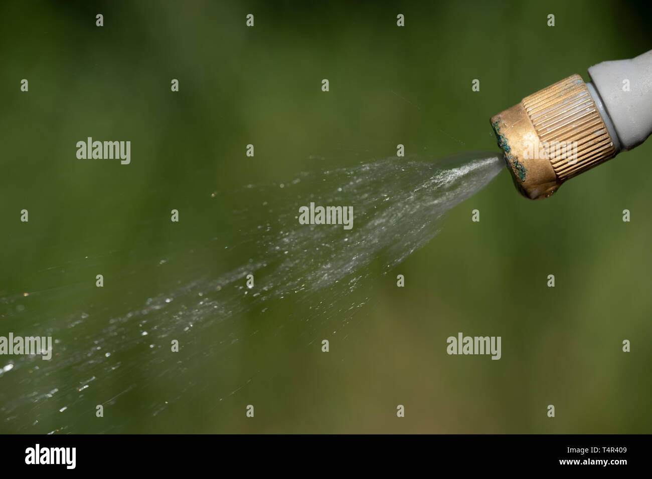 Spray nozzle releasing liquid Stock Photo Alamy